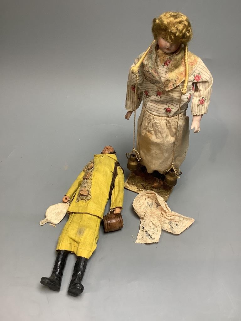 Two costume dolls, one papier mache, the other daisy seller bisque head, both 28cm